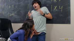 A busty teacher catches a guy jacking off in class and fucks him   Xozilla.com
