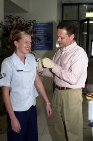 SENIOR AIRMAN (SRA) Melissa Sadler of the 191st Air Refueling Squadron  (ARS), Utah Air National Guard (ANG), receives her annual flu shot from  Guardsman CHIEF Nurse Lieutenant Colonel (LTC) Paul Blackburn -
