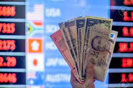 Convert indian rupee to malaysian ringgit. Hands Holding Multiple Currency Notes Like American Dollar Malaysian Ringgit Singapore Dollar Indian Rupee With Backgound Of A Currency Exchange Forex Chart Stock Photo Picture And Royalty Free Image Image 146942748