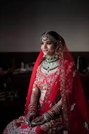 North Indian Bride In Red Lehenga And Contrasting Jewellery Indian Bride Bride Indian Matrimony