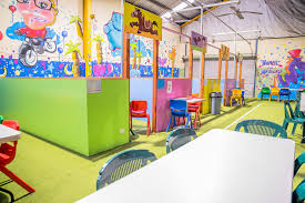 The navy blue walls and rustic wood floors are what makes the room feel more sophisticated than juvenile. Kids Parties Slides Playcentre Cafe Knoxfield