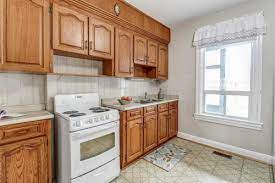 Consider painting a block of cabinets, such as the base cabinets, in a contrasting accent color to add interest. Wall Colors For A Dated Kitchen With Oak Cabinets