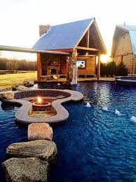 A Completely Natural Look With A Fire Pit At The Center Of The Pool With A Sitting Area Around It This Is Truly Beaut Backyard Dream Backyard Outdoor Fire Pit