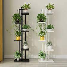 Crafted in durable metal and available in an assortment of colors. Show Off Your Beloved Plants With This Indoor Tiered Plant Stand In Either Black Or White Perfect For Yo House Plants Decor Plant Decor Vertical Garden Design