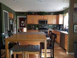 Paint kitchen walls a clean white to make soft brown oak cabinets stand out. Wall Paint Color For Oak Cabinets And Oak Floor