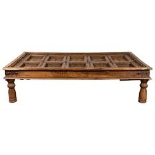 Lovely antique indian oak coffee table 59293 ingantiques co uk vintage rustic by mogulgallery tables large hardwood 92737 anglo bone inlaid thakat teak carved side lionheart interiors indischemöbel india furniture brass cladded long 6539 ant the s largest antiques website 228726 painted effect trunk. Antique Indian Wooden Palace Door Made Into A Coffee Table With Iron Braces At 1stdibs