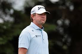 Watch: Lucas Glover removes shoes before picking ball out of hole