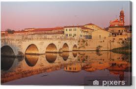 With some of the best nightlife in italy, rimini has a wealth of bars with dance floors, many by the beach, and the next door town of riccione is a clubbing mecca. Leinwandbild Tiberius Brucke Bei Sonnenuntergang Rimini Italien Pixers Wir Leben Um Zu Verandern