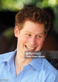 Prince Harry holds young patient Tyrell Richards when he visits the... News  Photo