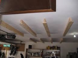 A ceiling board is then installed. Storage Idea Overhead Garage Storage Garage Storage Diy Overhead Garage Storage