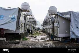 Cold winter in northern Iraq. A row of temporary shelters at Bhakara Camp  for Kurdish civilians who fled the ISIS invasion of Mosul Stock Photo -  Alamy