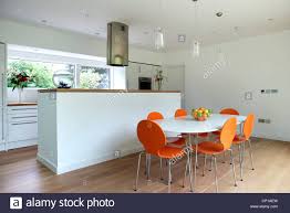 bright orange chairs at table in