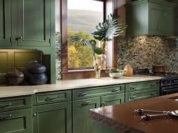 L shaped kitchen with creamy shaker kitchen cabinets paired with gray quartz countertops and beveled marble subway tile backsplash. Cream Countertop Green Cabinets Green Kitchen Cabinets Kitchen Cabinets Kitchen Style