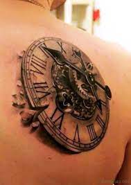 The clock dial evanesces itself to many small birds gliding up in the sky while its core continues to be on the ground. 52 Pretty Clock Tattoos On Shoulder