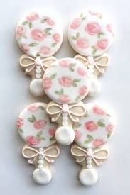 Chanel inspired baby shower cookies#edibleart #chanel #chic #babyshower #personalized #customsweets #thatsdarling. Floral Baby Rattle Cookie Favors Whipped Bakeshop Philadelphia