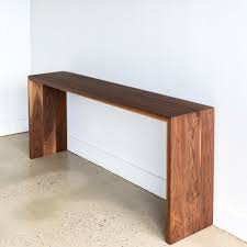 This table, which is set at the sofa back's level, is more of a floating style option. Modern Walnut Console Table What We Make