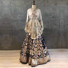 A Deep Blue Woven Banaras Lehenga Paired With Our Ivory Peplum Top Top With Hand Embroidery W Indian Fashion Dresses Lehenga Style Designer Party Wear Dresses