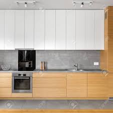 modern kitchen with grey tiling, wooden
