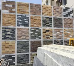 This residential home combines concrete and plaster columns with a wooden garage fronting the road. Top Stone Elevation Tile Dealers In Guntur Best Front Elevation Tile Dealers Justdial