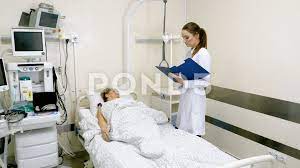 Caring Medical Worker In Hospital Talking To Elderly Woman At Her Bedside 4k Ad Hospital Talking Worker Caring Medical Hospital Worker