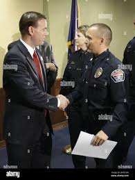 West Valley City Mayor Mike Winder, left, and West Valley City Deputy  Police Chief Mike Powell, right, shake hands following a news conference  Monday, May 20, 2013, in West Valley City, Utah.