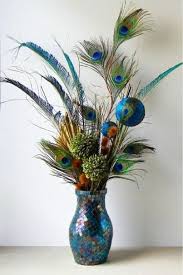 Long, colorful and graceful peacock feathers and plumes guarantee that any peacock themed room will showcase your decorating talent. 20 Elegant Room Decoration Ideas With Flower Vases Flower Vase Arrangements Artificial Flower Arrangements Peacock Decor