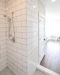 We Love A Fresh Bathroom Design Subway Tile For The Win Dark Grout Equals Easy Cleaning And A Great Compliment Shower Tile Tile Walk In Shower Tile Bathroom