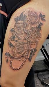 Rose and dagger stabbed skull tattoo. Tatandy Tattoostudio Uk Shaded Thigh Roses And Beads Tattoo Tattoo Artists Tattoos Tattoo Studio