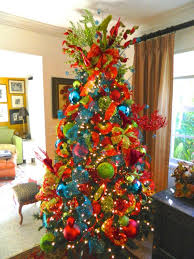 Similarly, the christmas tree adorned with white and silver colored shiny tree ornaments, silver star tree topper, and golden fairy lights add a festive charm to the dining room decorations. Reindeer Christmas Tree In Red Blue And Green Ornaments Whimsical Christmas Trees Red Christmas Tree Green Christmas Tree