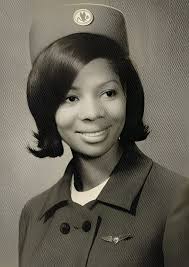 A United Airlines flight attendant talks with a passenger aboard a Douglas  DC-10, 1968.
