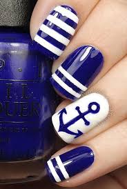 Two hands with blue and white nail polish and israel flag nail decoration. 40 Blue Nail Art Ideas For Creative Juice