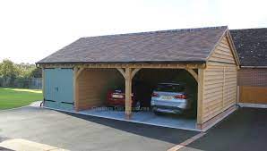 A Bespoke 3 Bay Oak Frame Garage With Painted Softwood Doors To One Bay Tile Roof Carport Designs Oak Frame House Building