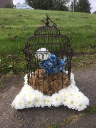 The pluto funeral flowers is created on a board approximately 3' x 2' or 90cm x 60cm using fresh flowers and professionally spray painted by our talented funeral florists. Scotmid Funerals On Twitter We Often See Some Very Unusual And Amazing Flowers For Funerals Here S A Beautiful Bird In A Cage As The Lady Loved Her Birds Especially Her Budgie Flowers