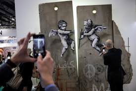 In england, banksy claims graffiti on the walls of oscar wilde's prison london (afp) british urban artist banksy claimed on instagram on thursday the authorship of a graffiti that appeared on the wall of the former british prison in reading (west london), where writer oscar wilde was detained. Banksy Displays Replica Separation Barrier At World Travel Market S Palestine Stand In Pictures The National