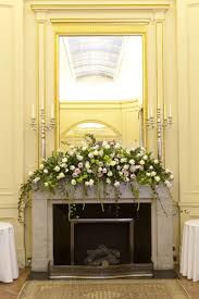 Cascading Fireplace Arrangement Bt Hayford Rhodes Wedding Fireplace Mantel Floral Arrangements Mantel Flowers