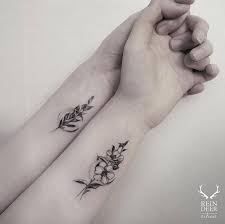 Girls like flower tattoos and if you want to give her preference than you can have her favourite flower inked on your body. Matching Flowers On The Wrist