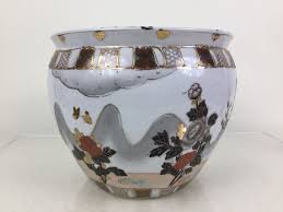 The potted plant living in this planter and fish the planter and fish bowl combo keeps the soil humid and cuts down watering needs. Japanese Fish Bowl Planter