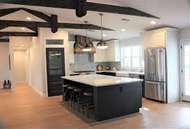 Brass pulls complement white kitchen cabinets topped with a white and gray quartz countertop, as rustic wood floating shelves are mounted against a vertical shiplap trim and beside white upper cabinets. Pin On Rafterhouse A Builder Interior Design Studio