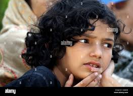 Shazia Anwar, 11, daughter of Syed Anwar Shah who has been missing for the  last eleven years take part during the International Day of the Disappeared  in Srinagar, the summer capital of