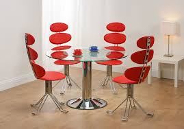 It creates an impression of space due to its minimalist design making it ideal for a small dining room. Adorable Unusual Dining Chairs With Red Color Contemporary Stylish And Round Table Glass Top Metal Base Also Table Lamp With Laminated Flooring White Wall Inspi