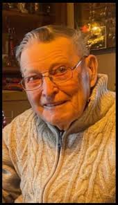 Mr. Alf Willson, father of future local M.P.P. Bill Willson, in his bus,  which was an upgrade from his original horse and carriage service. Mr.  Willson used to shuttle people from the