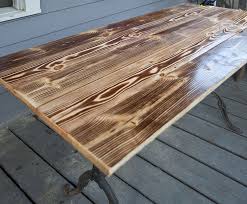 To save money, consider using hardwood veneer construction plywood. Build Your Own Charred Wood Table Top For A Dramatic Look