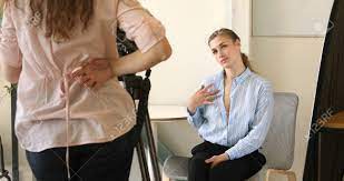 Woman Posing, Undressing In Front Of Camera On Casting. Beautiful Female In  Unbuttoned Shirt Sittng On Chair With And Seducing Colleague At Office.  Stock Photo, Picture and Royalty Free Image. Image 102846402.