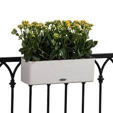 The black lattice of this trellis together with the molding of the posts and top piece suggest an oriental look, but different choices of wood, color, and shapes could create a victorian, rustic, coastal, or sleek. Balconissima Self Watering Railing Planter