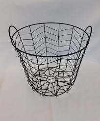 This large round coiled clothesline basket is made by wrapping upcycled selvages from cotton fabrics around many colors are present in this basket including white, brown, green, pinks, blues, and black. Black Wire Round Basket