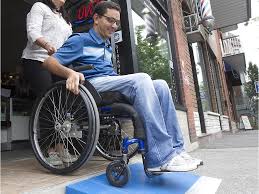 Specializes in the design and installation of ada compliant wheelchair ramps in michigan. Man With Disability Building Free Wheelchair Ramps For Montreal Businesses Wheelchair Ramp Wheelchair Montreal