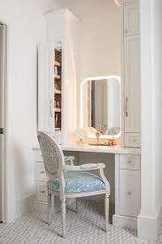 A Curved Light Vanity Mirror Is Flanked By White Pull Out Cabinets Accenting A White Make Bathroom With Makeup Vanity Small Bathroom Redo Lighted Vanity Mirror
