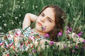 Teenage Girl Lies in the Grass with Clover