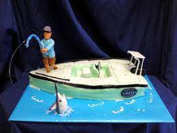 The fun novelty cake is shaped to look like a large swell below the fishing boat, with a fondant shark head coming off one side. Pin By Divine Desserts On Boy S Birthday Cakes Boat Cake Boy Birthday Cake Fish Cake