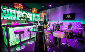 slide furnished the five night club in geneve switzerland with lacquered black peak tables